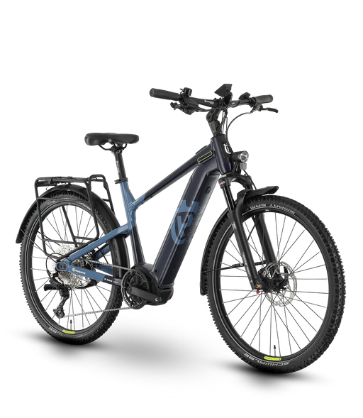 A step-through electric bicycle with a dark blue-gray frame, black components, and knobby tires, shown from a three-quarters front angle on a white background.